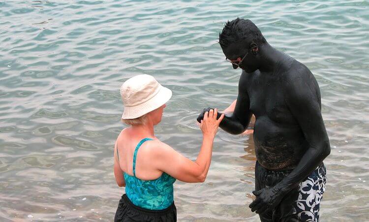 Man covered in Dead Sea mud