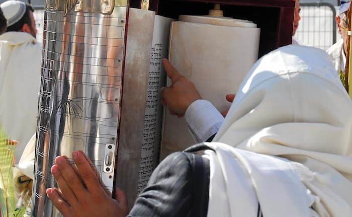 Man reading Torah Scroll at Western Wall