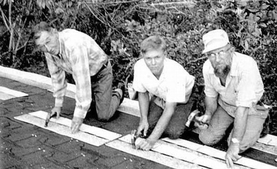 Three men help to rebuild after Hurricane Celia, August 23, 1970. 