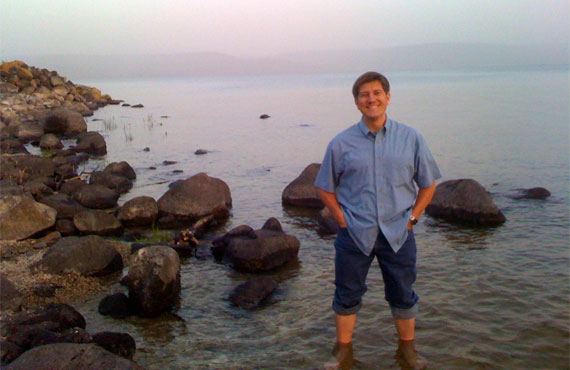 Standing on the shores of Tabgha, beside the Sea of Galilee